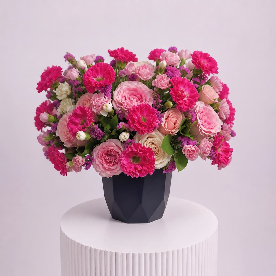 Vibrant Pink Carnation Rose Bouquet with Statice in Faceted Vase